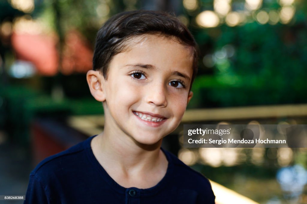 Portrait of a young Hispanic boy looking at the camera and smiling