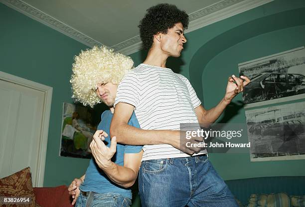 two men playing air guitar - funny friends stock pictures, royalty-free photos & images
