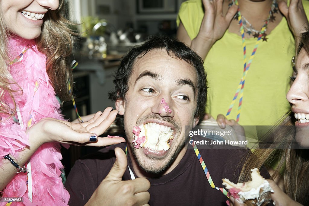 Man with his mouth full of cake