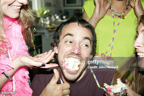 man with his mouth full of cake - cake party stock pictures, royalty-free photos & images