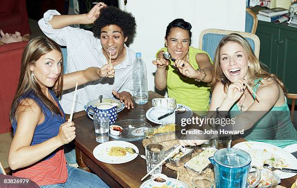 friends eating fast food posing to camera - sitting at table looking at camera stock pictures, royalty-free photos & images