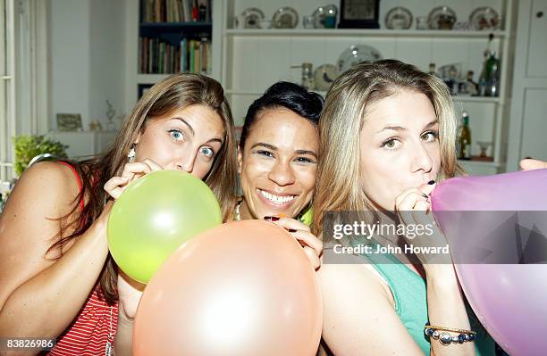 three friends posing with balloons - blowing up balloon bildbanksfoton och bilder