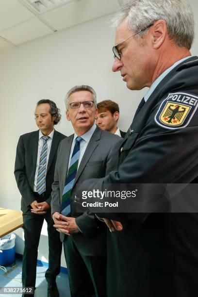 German Interior Minister Thomas de Maiziere is shown the new facial recognition system at the Suedkreuz train station on August 1, 2017 in Berlin,...