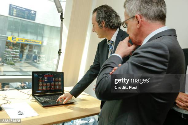 German Interior Minister Thomas de Maiziere is shown the new facial recognition system at the Suedkreuz train station on August 1, 2017 in Berlin,...