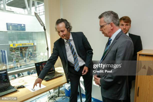 German Interior Minister Thomas de Maiziere is shown the new facial recognition system at the Suedkreuz train station on August 1, 2017 in Berlin,...