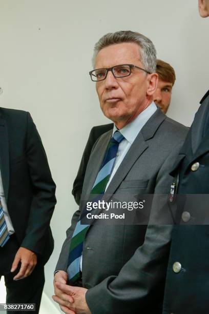German Interior Minister Thomas de Maiziere is shown the new facial recognition system at the Suedkreuz train station on August 1, 2017 in Berlin,...