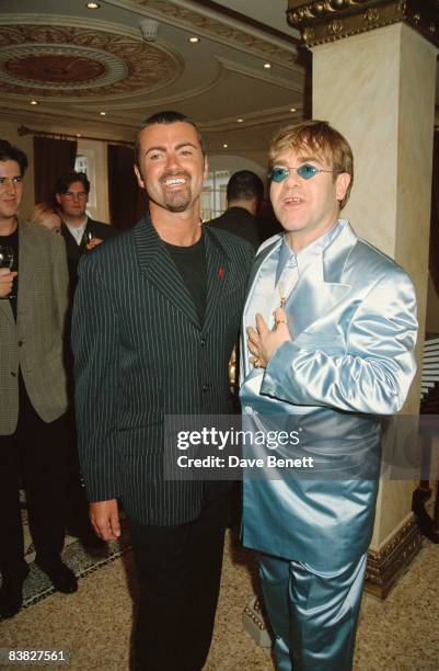 Singers George Michael and Elton John at the Gianni Versace 'Men Without Ties' launch party in London, 14th June 1995.