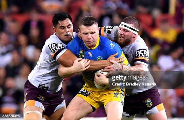 Nathan Brown of the Eels is wrapped up by the defence during the round 25 NRL match between the Brisbane Broncos and the Parramatta Eels at Suncorp...