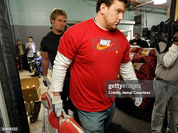 Giants Football players Adam Koets and Chris Snee load trucks with turkeys for Thanksgiving dinner for the Food Bank Community Kitchen of West Harlem...