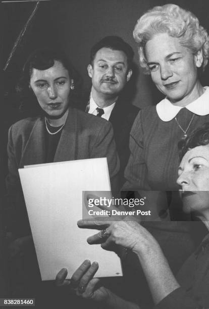 What are they peering at? L - R Mary Elizabeth Sefton, Barbara Schindler, Dr. Alfred D. Kleyhauer, Mrs. Evelyn M. Lewis. Credit: Denver Post