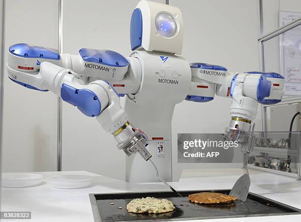 Japanese giant Yaskawa Electric's industrial robot Motoman turns over an "okonomiyaki", a Japanese pancake on a hot plate for a demonstration of...