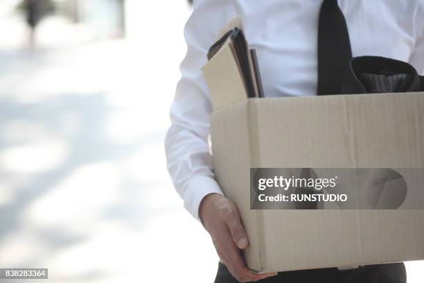 close-up of businessperson standing with cardboard box outside office - possession stock pictures, royalty-free photos & images