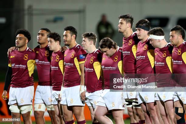 Southland players stand in silence to acknowledge the passing of Former All Blacks player, Sir Colin Meads, during the Mitre 10 Cup match between...
