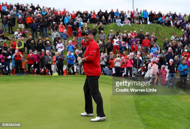 Thomas Bjorn of Denmark on the 16th green as spectators wear masks to celebrate his 500th European Tour appearance during day one of Made in Denmark...