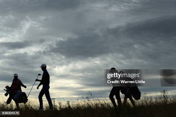 Gary Hurley of Ireland hands his club to his caddie as he walks off the 12th tee during the first round of the Made in Denmark at Himmerland Golf &...