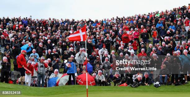 Fans mark the 500th European Tour appearance of Thomas Bjorn of Denmark by doning look a like face masks on the 16th green during the first round of...