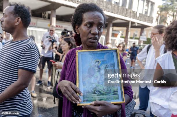 Refugee with the image of St. George, during the removal of refugees by the police who camped in the gardens of Independence Square after their...