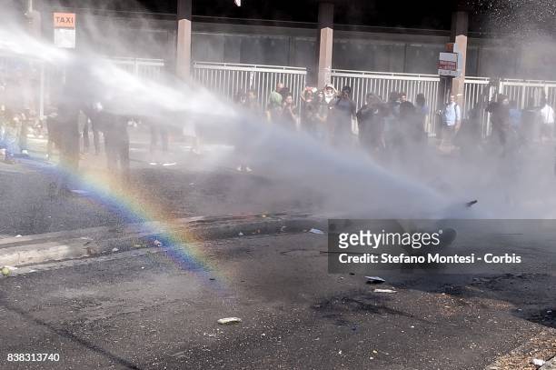 Refugee woman is struck by the water cannons by the police during the removal of refugees who camped in the gardens of Independence Square after...