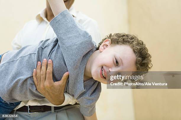 boy pretending to be a plane, being held by his father - pretending to be a plane stockfoto's en -beelden