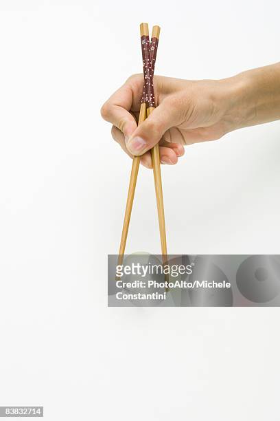 hands using chopsticks to hold transparent globe, cropped view - chopsticks stock pictures, royalty-free photos & images