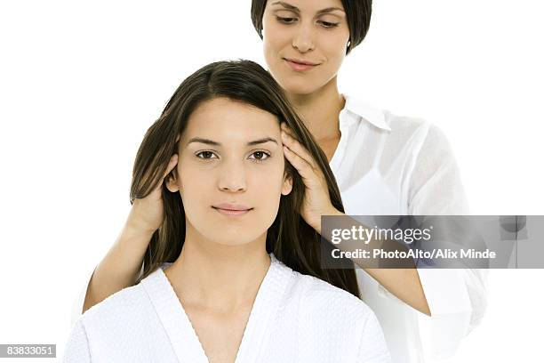 woman receiving head massage, looking at camera - touching hair stock pictures, royalty-free photos & images