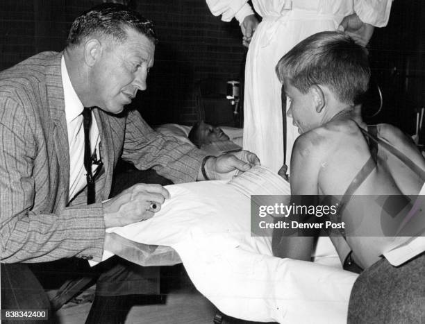 Sheriff Guy Van Cleave of Adams County talks with "disaster victim" Don Chambers who lives a mile north of Brighton. Sheriff's officers and members...