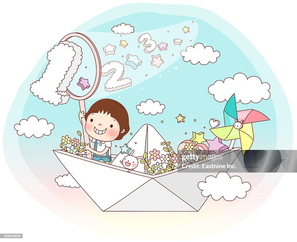 Boy sitting in paper boat