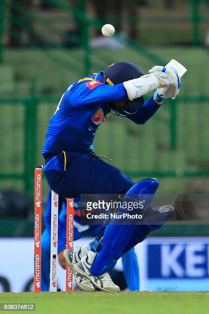 Sri Lankan cricket captain Upul Tharanga avoids a bouncer ball during the 2nd One Day International cricket match between Sri Lanka and India at the...