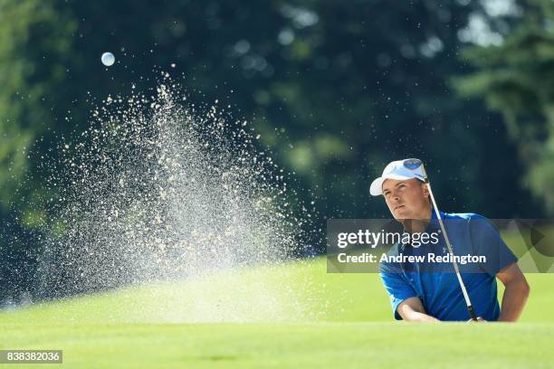 Jordan Spieth of the United States plays a shot from a bunker on the 13th hole during round one of The Northern Trust at Glen Oaks Club on August 24,...