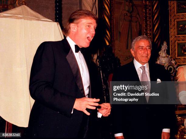 American real estate developer Donald Trump introduces musician Tony Bennett during a 'roaring 20's' party at the Mar-a-Lago estate, Palm Beach,...