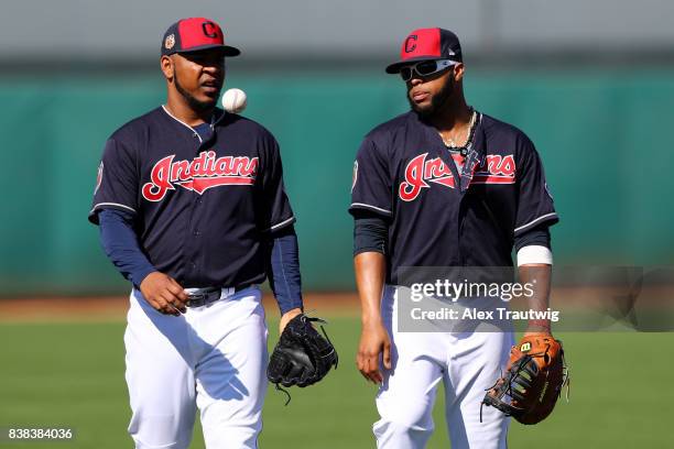 Edwin Encarnacion and Carlos Santana of the Cleveland Indians speak during a workout on Friday, February 24, 2017 at Goodyear Ballpark in Goodyear,...