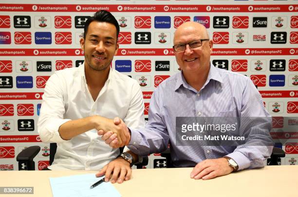 Maya Yoshida of Southampton poses with director Les Reed after signing a new contract at the Staplewood Campus on August 24, 2017 in Southampton,...