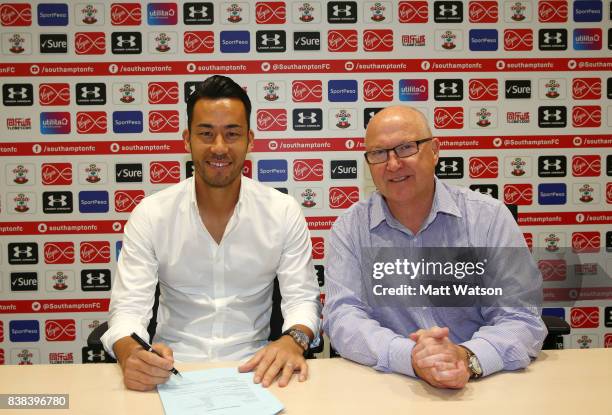 Maya Yoshida of Southampton poses with director Les Reed after signing a new contract at the Staplewood Campus on August 24, 2017 in Southampton,...