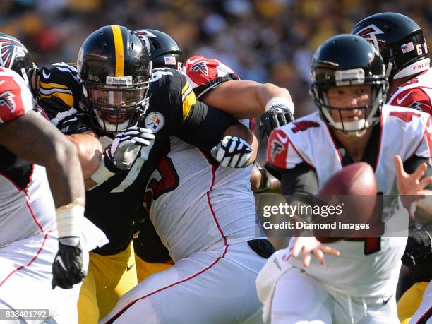 Defensive end Cameron Heyward of the Pittsburgh Steelers fights off blocks as he pursues quarterback Matt Simms of the Atlanta Falcons in the second...
