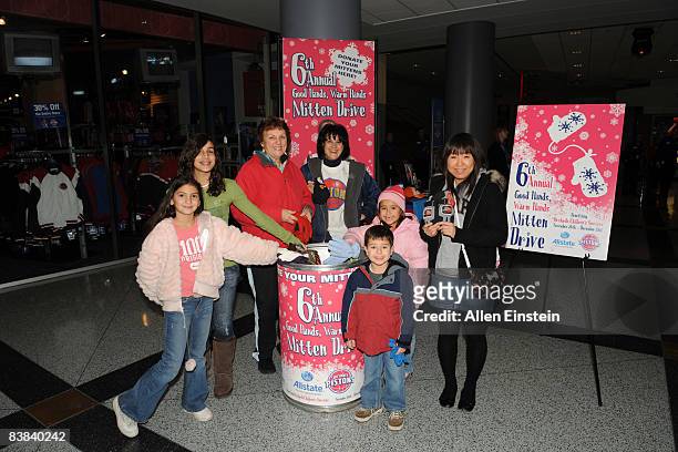 Fans participate in a Mitten Drive sponsored by the Pistons and Allstate Insurance Company called Good Hands, Warm Hands before a game featuring the...