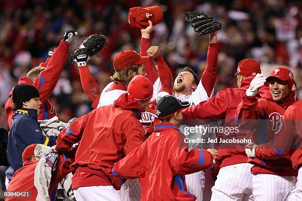 Brad Lidge of the Philadelphia Phillies celebrates with his teammates after their 4-3 win against the Tampa Bay Rays during the continuation of game...