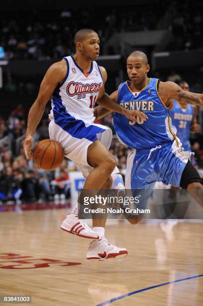Eric Gordon of the Los Angeles Clippers handles the ball against Dahntay Jones of the Denver Nuggets during their game at Staples Center on November...