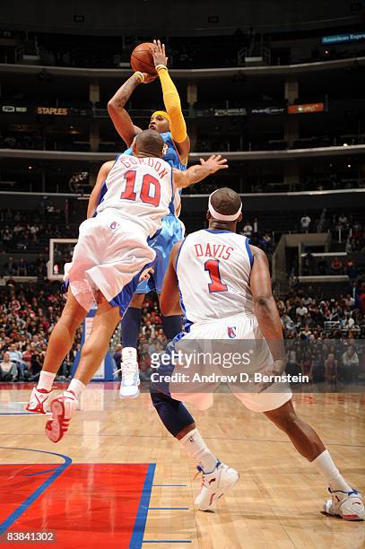 Carmelo Anthony of the Denver Nuggets shoots the go-ahead jumpter against Eric Gordon of the Los Angeles Clippers to put the Nuggets ahead of the...