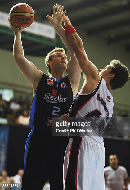 Tony Ronaldson of the New Zealand Breakers is put under pressure by Alex Loughton of the Perth Wildcats during the round 11 NBL match between the New...