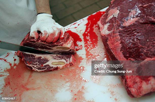 An employee prepares imported U.S. Beef at a store on November 27, 2008 in Seoul, South Korea. The import of U.S. Beef, which is sixty to seventy...