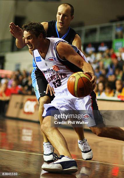 Luke Kendall of the Perth Wildcats takes the ball past Phill Jones of the New Zealand Breakers during the round 11 NBL match between the New Zealand...