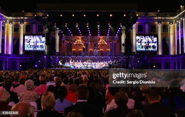 Spectators watch Violinist and composer Andre Rieu and his orchestra perform live on stage at ANZ Stadium on November 27, 2008 in Sydney, Australia.