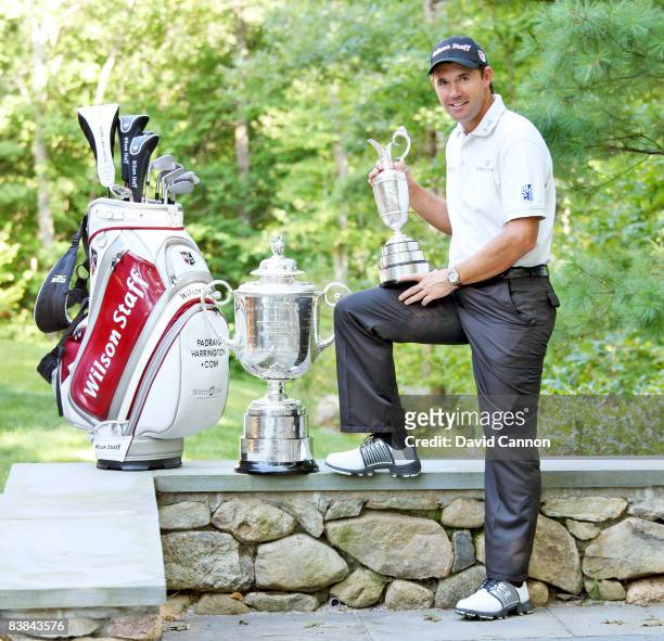 Golfer Padraig Harrington of Ireland poses with the Claret Jug and Wanamaker Trophy following his wins in the 137th Open Championship at Royal...