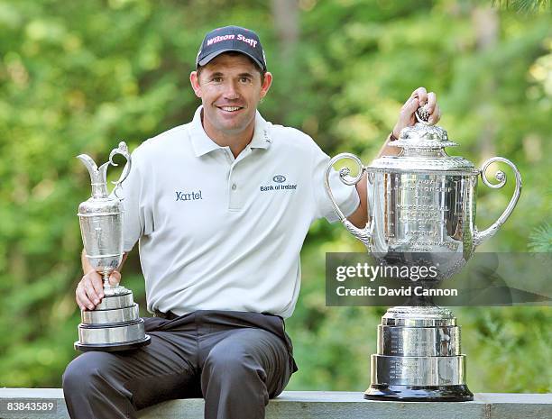 Golfer Padraig Harrington of Ireland poses with the Claret Jug and Wanamaker Trophy following his wins in the 137th Open Championship at Royal...