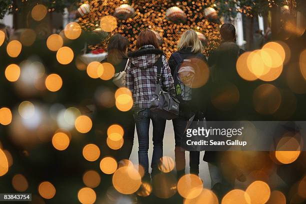 Shoppers walk among illuminated Christmas trees at the Arkaden shopping mall on November 27, 2008 in Berlin, Germany. German retailers are hoping for...