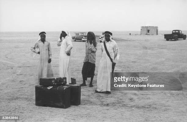 Group of servants and police officers guard the luggage of Sheikh Ali bin Abdullah Al-Thani in Qatar, September 1953.