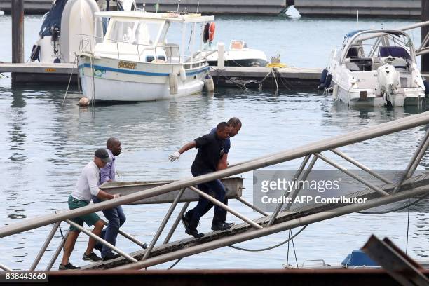 The body of one of the victims of a boat wreck, after a ferry sank off the northeastern state of Bahia, is loaded at the Maritime Terminal of...