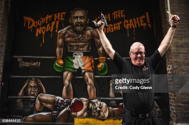 Dublin , Ireland - 24 August 2017; Damien Walsh, from Ashington, Dublin, pictured in front of a mural of Conor McGregor and Floyd Mayweather outside...