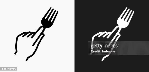 hand holding fork icon on black and white vector backgrounds - hand fork stock illustrations