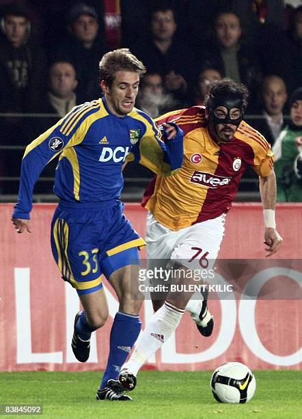 Servet Cetin of Galatasaray fights for the ball with Marko Devic of Metalist Kharkov on November 27, 2008 during a UEFA Cup 3rd Group match between...